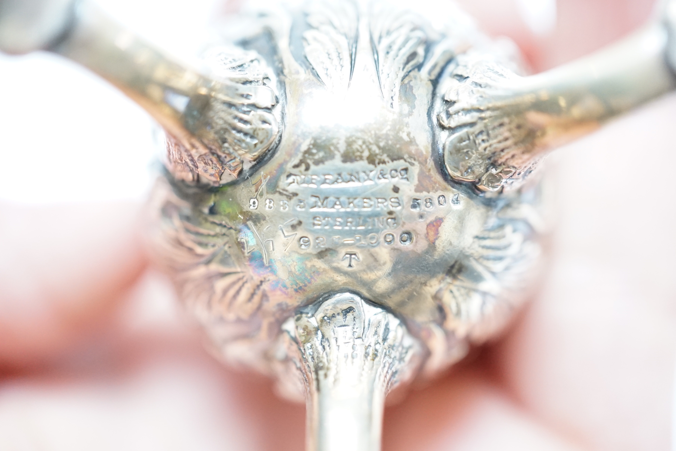 A pair of late 19th century Tiffany & Co sterling pepperettes, on tripod supports, 9cm, 157 grams.